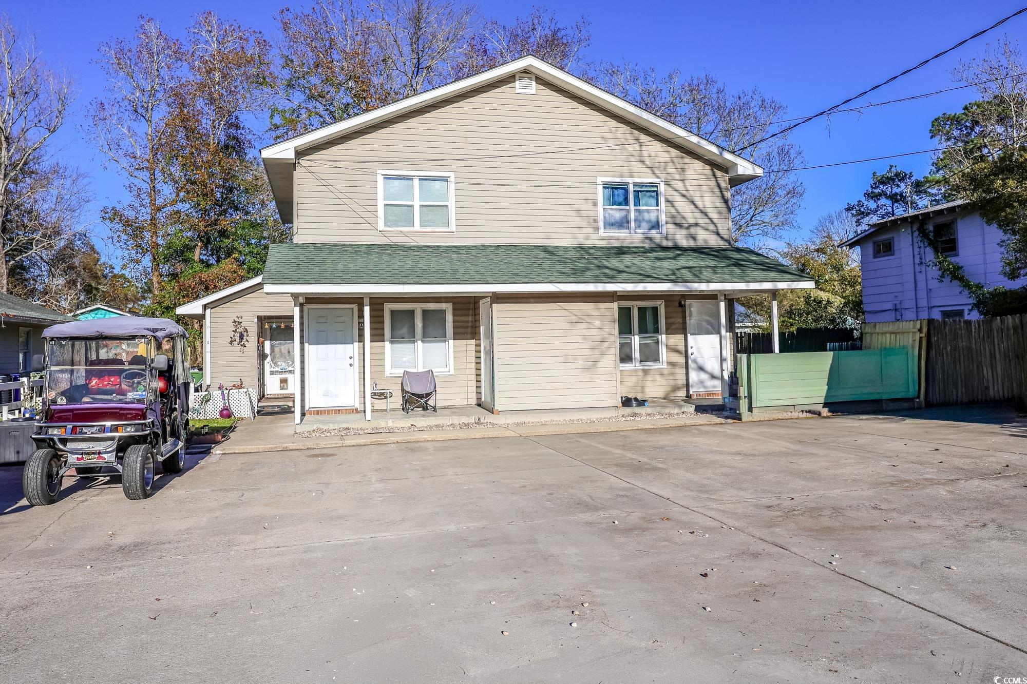 View of front of house featuring a porch and roof with shingles