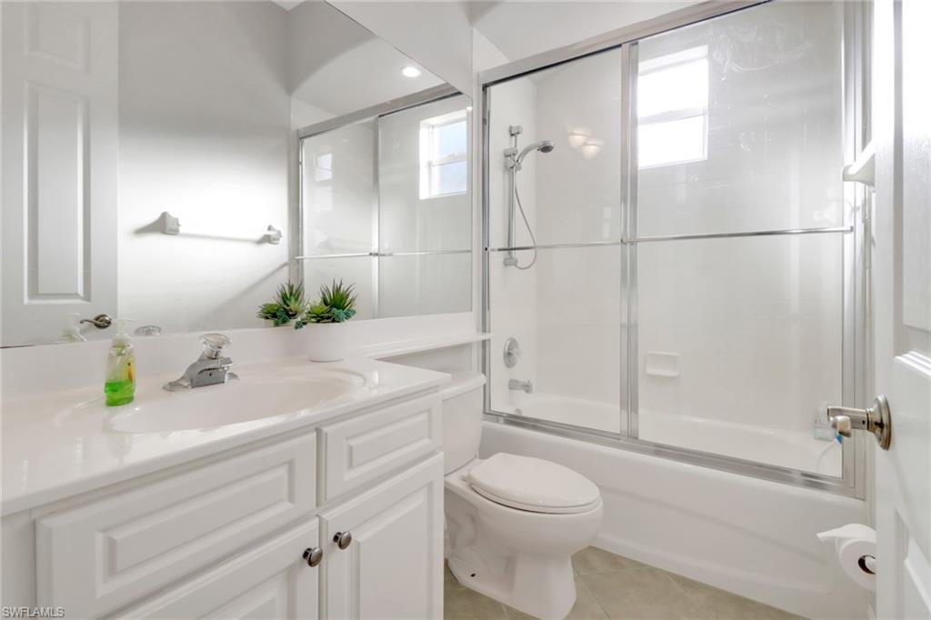 6757 Bent Grass Drive Naples, FL 34113 - Photo 18 of 27 a bathroom with a sink a toilet and shower