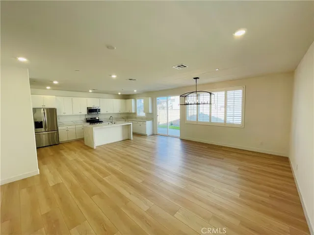 a kitchen with stainless steel appliances a stove top oven and cabinets