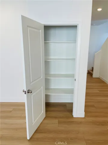 a view of hallway with wooden floor