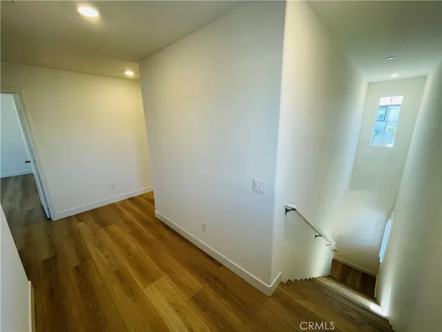 a view of hallway with wooden floor