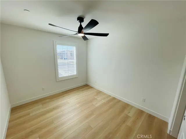 a view of empty room with ceiling fan