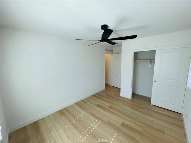 a room with a wooden floor and tub