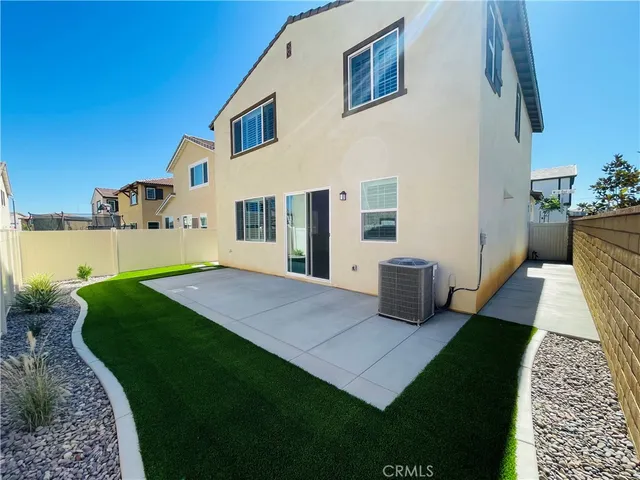 a view of a house with a swimming pool and sitting area