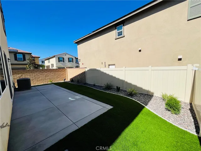a view of a house with swimming pool and sitting area