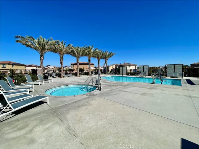 a view of a yard with a table and chair under an umbrella