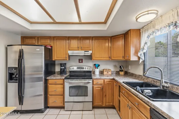 a living room with furniture pool table and a wooden floor