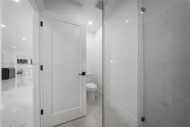 a bathroom with a glass shower door