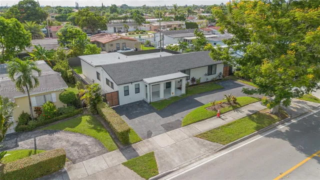 an aerial view of a house with a yard