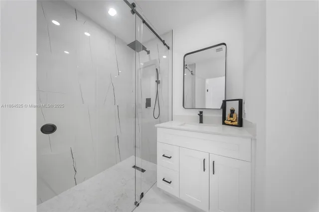 a bathroom with a shower sink and mirror