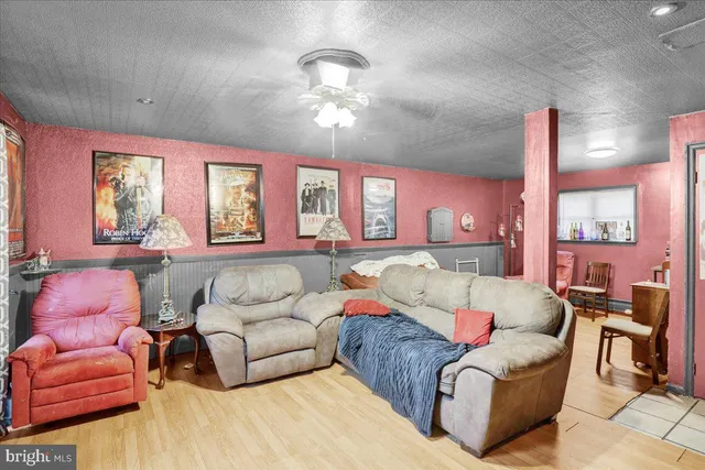 a living room with furniture a large window and a chandelier