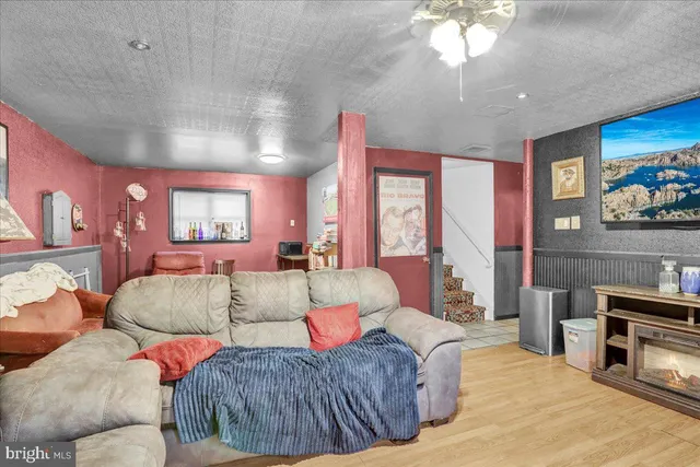 a living room with furniture a large window and a flat screen tv