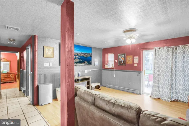 a living room with a couch and a chandelier