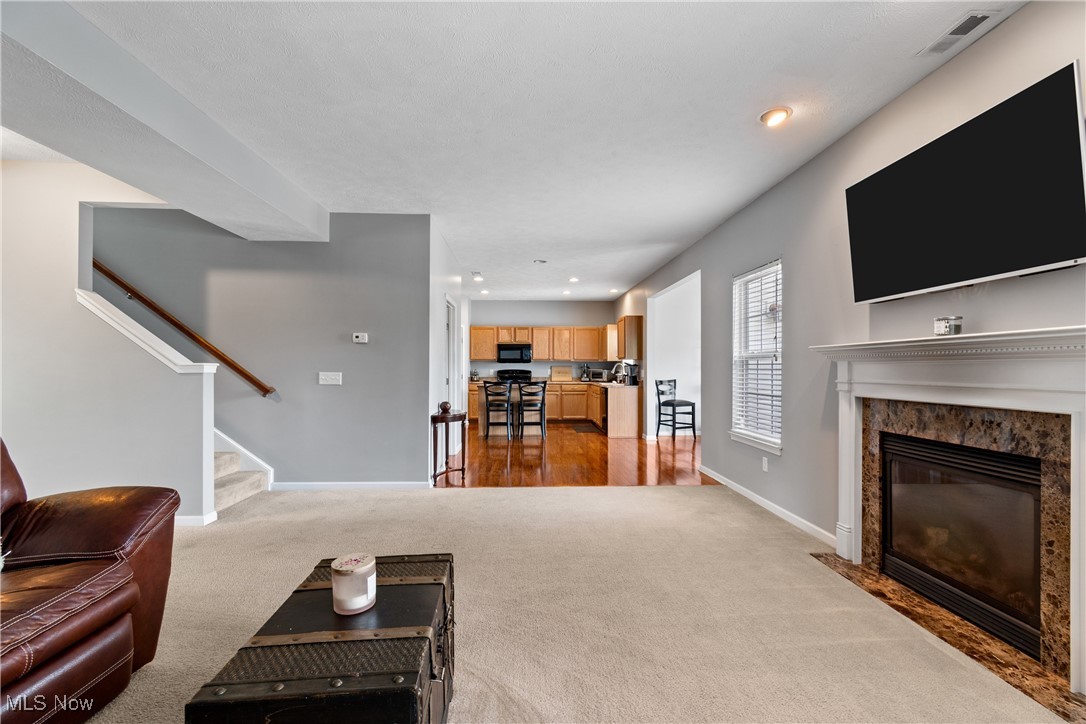 4467 Ridgestone Way Medina, OH 44256 - Photo 6 of 31 Carpeted living room with a premium fireplace