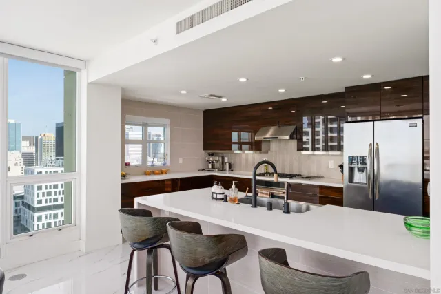 a kitchen with kitchen island a sink stainless steel appliances and window
