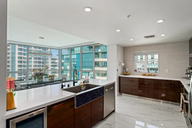 a kitchen with stainless steel appliances kitchen island granite countertop a sink and cabinets