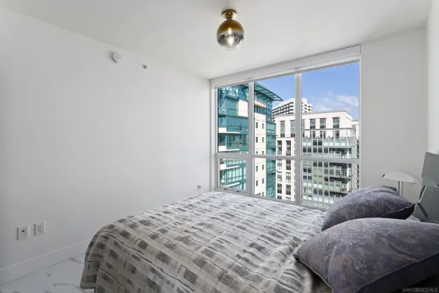a living room with furniture tv and a large window