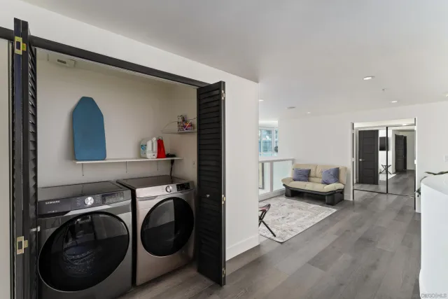 a bedroom with furniture and large windows