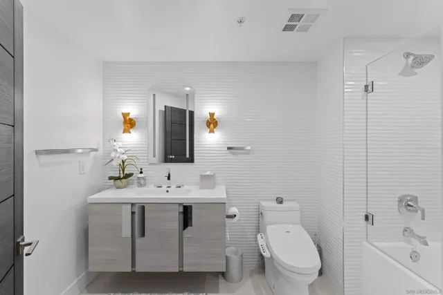 a spacious bedroom with a bed and glass window