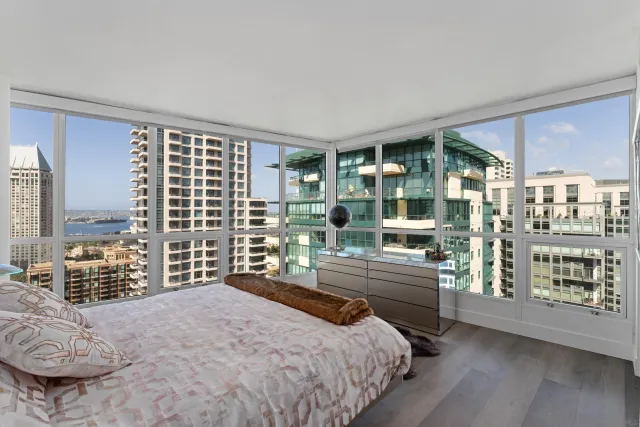 a bedroom with a bed and a large mirror