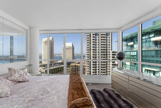 a bathroom with a double vanity sink a toilet and a large mirror
