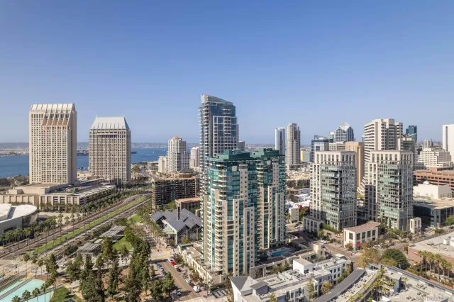 a bedroom with furniture and large windows