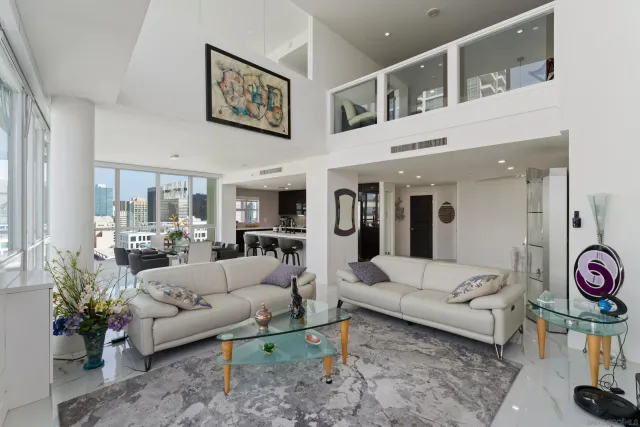 a dining room with furniture a chandelier and wooden floor
