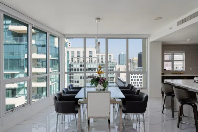 a dining room with furniture and a floor to ceiling window
