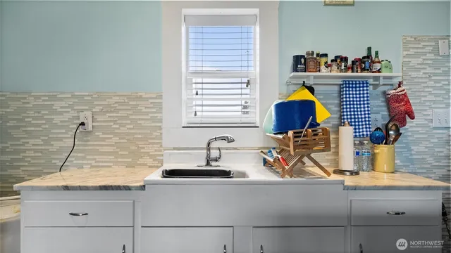 a kitchen with a sink and a stove