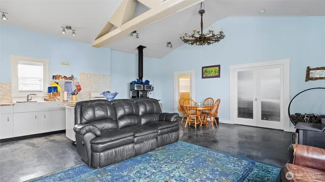 a living room with furniture a chandelier and a dining room