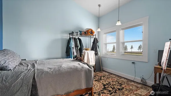 a bedroom with bed and a window