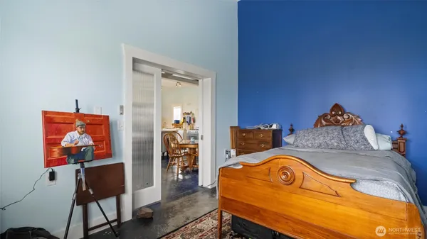 a bed room with a bed and a chair