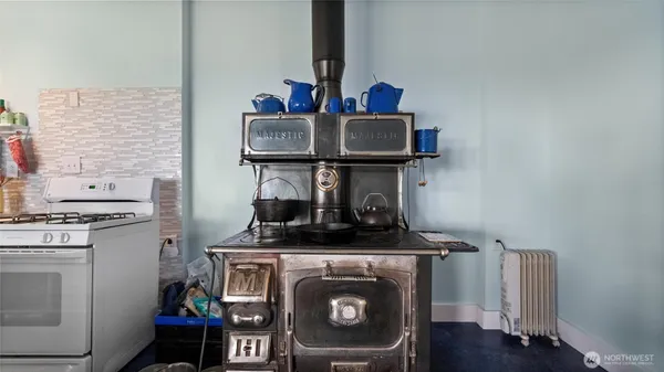 a view of kitchen stove and wooden floor