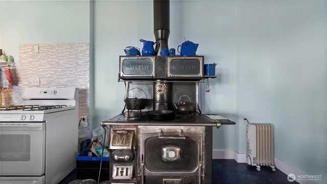 a view of kitchen stove and wooden floor