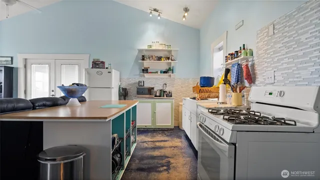 a kitchen with a sink stove and cabinets