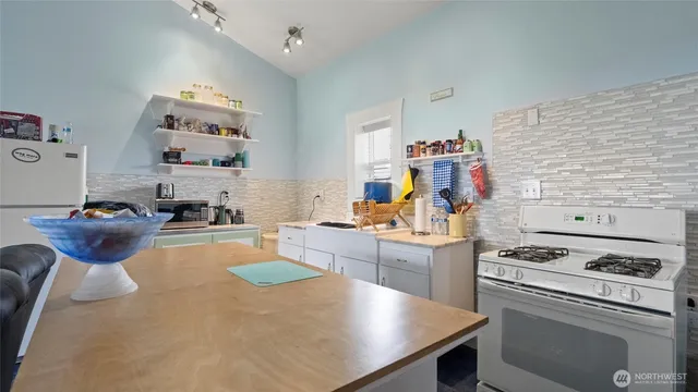 a kitchen with a stove a refrigerator and a sink