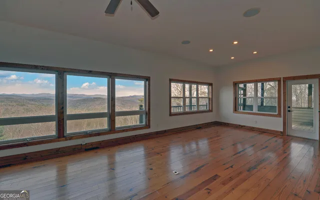 a view of a kitchen with wooden floor and a sink