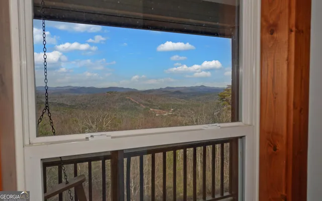 a view of a balcony with wooden floor & fence