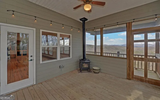 a view of a hallway with wooden floor and entryway