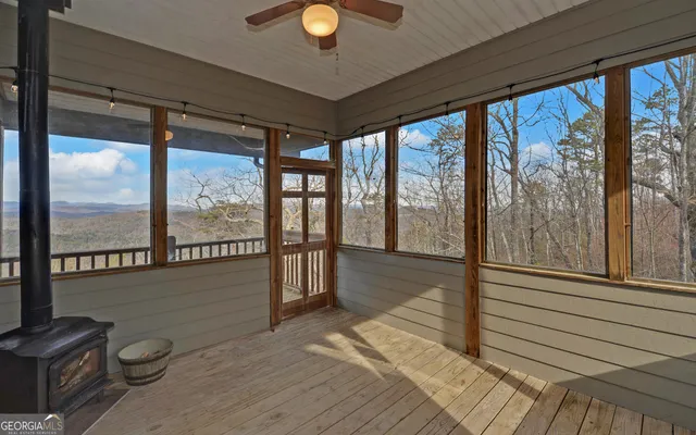 a view of wooden floor wooden shelves and windows in a room