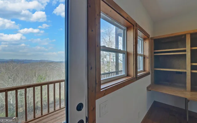 a view of closet with wooden floor