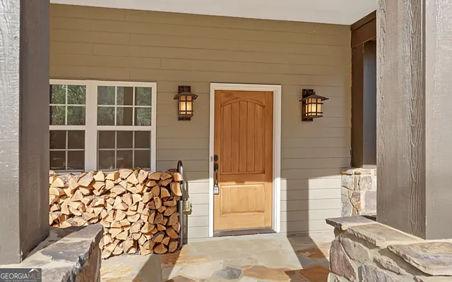 a view of a hallway with wooden floor and closet