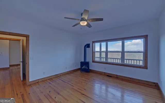 a view of a balcony with wooden floor and fence