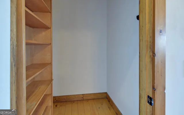 a open kitchen view with fireplace and wooden floor