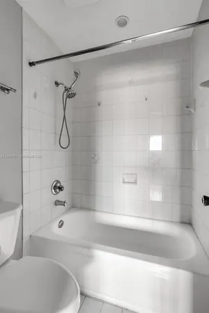 a bathroom with a bathtub and shower