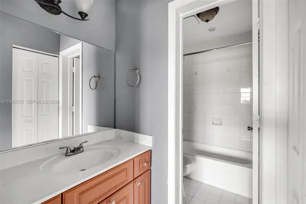 a bathroom with a shower sink and mirror
