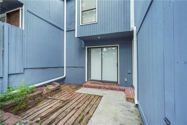 a bedroom with a bed and a potted plant