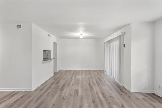a view of a room with wooden floor
