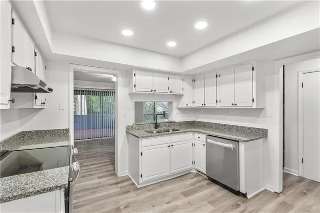 a kitchen with a sink stove and cabinets