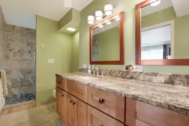 a bathroom with a double vanity sink and a mirror
